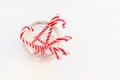 Candy canes in glass jar, closeup. Christmas and new year theme. Winter, seasonal sweets. Top view, flat lay