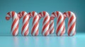 Candy canes in a row on a light blue background Royalty Free Stock Photo