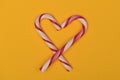 Candy canes shaped like a heart crossed at the bottom