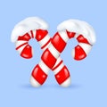 Candy canes in snowdrifts. Traditional Christmas lollipops