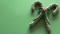 Candy canes tied in a bow on festive green background