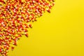 Candy Corn on Bright Yellow Background for Halloween and Fall Festivities. Royalty Free Stock Photo