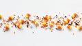 Candy corn, eyeballs and Halloween sprinkles, against a white background.