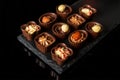 Candy with cream and nuts on slate board. Assorted chocolate on black isolated background. Idea for dessert in restaurant Royalty Free Stock Photo