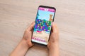 Candy Crush Saga puzzle video game on modern smart phone in kid hands close-up