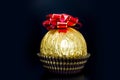 Candy in gold foil on black background Royalty Free Stock Photo