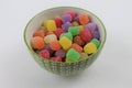 Candy Gum Drops in a Decorative Green and White Glass Bowl on a White Background Isolated