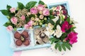 Candy handmade decorated in a wooden box with fresh flowers bouquet Royalty Free Stock Photo