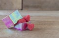 Candy hearts in a gift box on wooden background