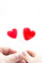 Candy-hearts in the hands of a man and a girl. a symbol of love