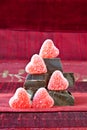 Candy Hearts on a Pile of Dark Chocolate Pieces