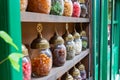Candy jars on the shelf of the candy shop in the street.