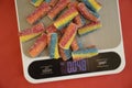 Candy , kitchen scales on a colored background dieting Royalty Free Stock Photo