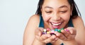 Candy, like gold to a kid. Studio shot of a cute young girl holding a handful of colorful jelly beans.