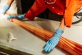 Candy maker rolling handmade orange and white stripe candy by hands with gloves in Shiroi Koibito Park at Sapporo in Hokkaido.