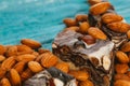 Candy paste and almonds on blue wooden background