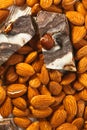 Candy paste and almonds on white wooden background