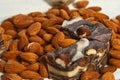 Candy paste and almonds on white wooden background