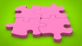 Candy pink puzzle pieces set together on green background Royalty Free Stock Photo