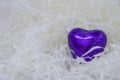 Candy purple heart on a white