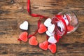 Candy shape heart in glass jar on wooden table