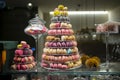 Candy shop display with colorful pyramid of French macarons biscuits Royalty Free Stock Photo