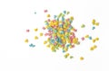 Candy sprinkles. Colorful cake sprinkles scattered over white background. Royalty Free Stock Photo