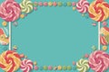 Candy-themed rectangular frame with colorful lollipops and round candies on turquoise. Royalty Free Stock Photo