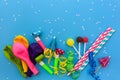 Candy, whistles, streamers, balloons on holiday table. Concept of children`s birthday party.