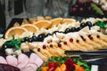 Candybar in a restaurant. Decorated white table fool of sweet pastry