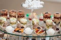 Candybar in a restaurant. Decorated white table fool of sweet pastry