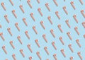 Christmas candy canes with seamless pattern on pastel blue background. Royalty Free Stock Photo