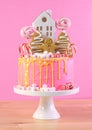 Candyland children`s party Christmas cake in pink and gold table setting.