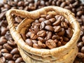 Cane basket filled with coffee beans against the background of spilled coffee