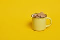Cane brown sugar cubes in a yellow cup on a yellow background Royalty Free Stock Photo