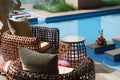 Cane chairs beside pool Royalty Free Stock Photo