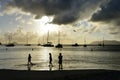 Family on the beach at Cane Garden Bay with boats in the background, Tortola, BVI Royalty Free Stock Photo