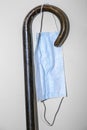 Cane of old person with a protective mask