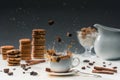 Cane sugar cubes splashing in cup with hot black coffee in front of biscuits Royalty Free Stock Photo