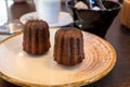 Canele, French pastry flavored with rum and vanilla, specialty of Bordeaux region, France, served with cup of black coffie in