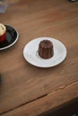 Caneles de bordeaux in white plate on wooden table. Traditional French sweet dessert