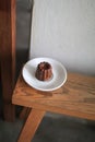 Caneles de bordeaux in white plate on wooden table. Traditional French sweet dessert