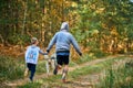 Canicross cross country running with dog, father and son running with Husky dog, family sports