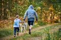 Canicross cross country running with dog, father and son running with Husky dog, family sports