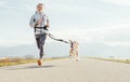 Canicross exercises. Female runs with his beagle dog and happy smiling. Autumn spring outdoor sport activity