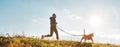 Canicross exercises. Man runs with his beagle dog at sunny morning. Healthy lifestyle concept. Royalty Free Stock Photo