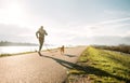 Canicross exercises. Outdoor sport activity - man jogging with his beagle dog Royalty Free Stock Photo