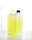 Canister with yellow car shampoo concentrate on a white background, isolate. Cleaning a car from dirt, shampoo for a