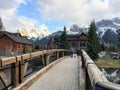 A couple going for an evening walk across a bridge surrounded by beautiful homes and mountains in a beautiful neighbourhood