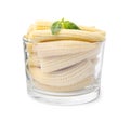 Canned baby corns with basil in glass on white background Royalty Free Stock Photo